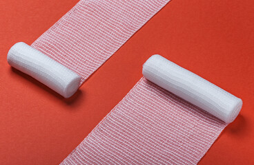 medical bandages for first aid on a red background