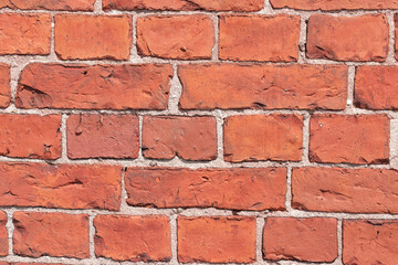 Obraz premium Red brick wall with white putty close up. Brick-pattern style. Decorative background. Place for text.