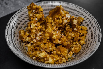 a bowl of caramel popcorn. close up of homemade popcorn. food to watch a movie