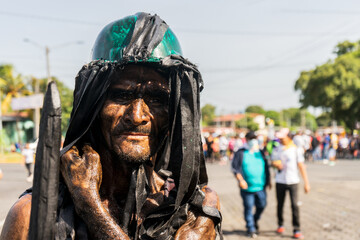 Obraz na płótnie Canvas Portrait of a devotee of Santo Domingo paying a promise in a traditional festival in Managua, Nicaragua
