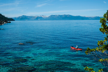 Tourist is kayaking in the lake with a very clear water. summer activity in lake tahoe.