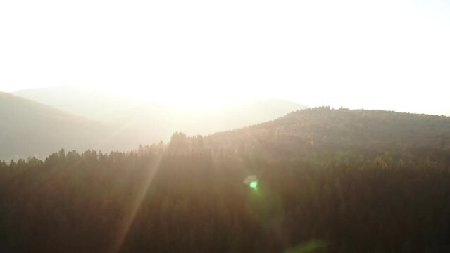 Morning natural landscape in mountains. Bright sun blinds eyes