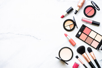 Makeup professional cosmetics on white marble background. Flat lay image with copy space.