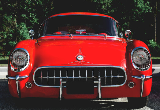 Closeup front bumper and headlights of the vintage retro red Chevrolet Corvette car