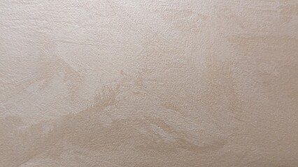 Close-up of golden plaster on the wall, background