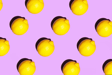 Colorful lemon pattern on pastel light purple background. Minimalistic fruit concept. Creative summer nature composition.