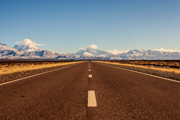 National highway number 40 in Argentina paved with snowy mountains in the background