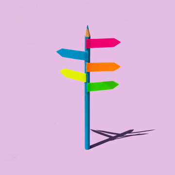 Creative back to school concept. Minimal composition with pencil as signpost on pastel bright purple background. Back to school idea. Education and guidance inspiration.