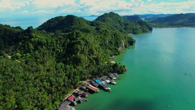 Drones are flying over Ao Kram in the beautiful tropical sea. Fisherman village and homestay, famous tourist attraction in Chumphon. Southern Thailand. travel vacation concept. 4k
