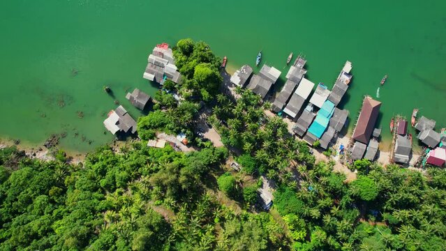 Fishing village at Ban Ao Kram. Ban Ao Kram has a homestay for tourists to stay and learn about the lifestyle of fishermen. Tropical sea at Chumphon, Thailand. Cinematic drone shot. 4k
