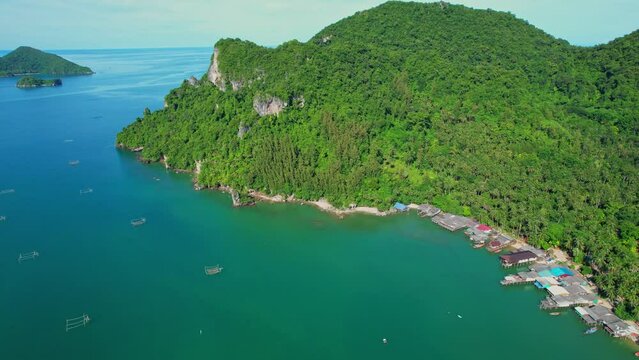 Drones are flying over Ao Kram in the beautiful tropical sea. Fisherman village and homestay, famous tourist attraction in Chumphon. Southern Thailand. travel vacation concept. 4k
