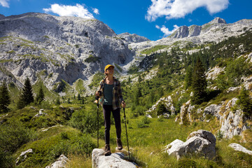 Fototapeta na wymiar Woman Hiker Admiring Nature in Idyllic Subalpine Environment under Mount Krn - Julian Alps Slovenia