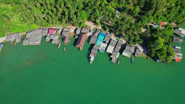 Fishing village at Ban Ao Kram. Ban Ao Kram has a homestay for tourists to stay and learn about the lifestyle of fishermen. Tropical sea at Chumphon, Thailand. Cinematic drone shot. 4k
