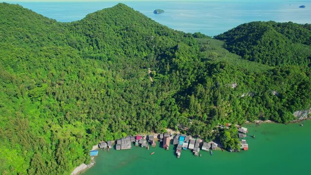 Drones are flying over Ao Kram in the beautiful tropical sea. Fisherman village and homestay, famous tourist attraction in Chumphon. Southern Thailand. travel vacation concept. 4k
