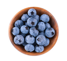 Fresh blueberry in wooden bowl, isolated on white background. Bilberry or whortleberry. Clipping path. Top view.