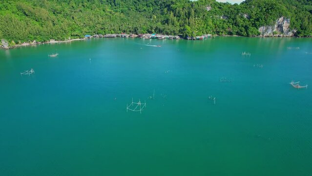 Drones are flying over Ao Kram in the beautiful tropical sea. Fisherman village and homestay, famous tourist attraction in Chumphon. Southern Thailand. travel vacation concept. 4k

