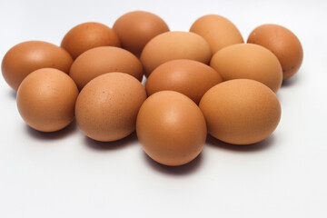 Fototapeta na wymiar Close-Up of Fresh Raw Chicken Eggs on a White Background