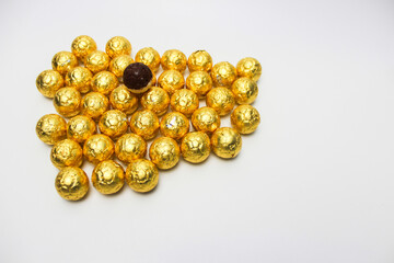 Soccer Ball-shaped chocolates in gold foil. Isolated