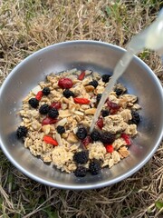 Pouring grapefruit juice on granola cereal