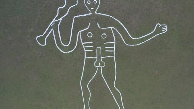 4k aerial video of The Cerne Abbas Giant is a hill figure near Cerne Abbas in Dorset, England. 55 metres high, standing nude male with a prominent erection and wielding a large club in its right hand