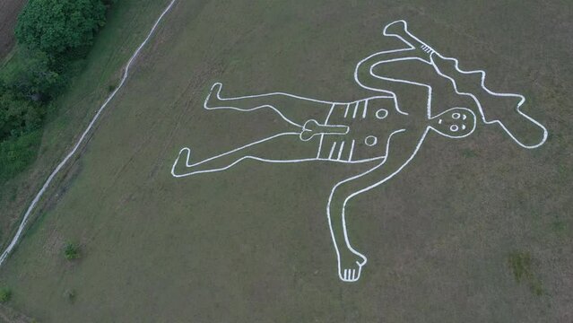 4k aerial video of The Cerne Abbas Giant is a hill figure near Cerne Abbas in Dorset, England. 55 metres high, standing nude male with a prominent erection and wielding a large club in its right hand