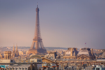 Eiffel tower and parisian roofs at clear sky sunrise Paris, France