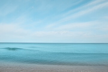 Beautiful view of sea shore under blue sky on sunny day