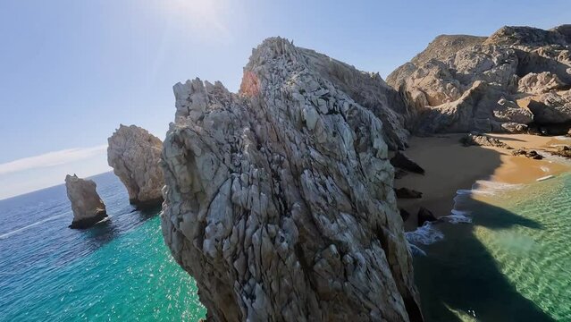 FPV drone shot over and around the Arch rock formations in Cabo San Lucas, Mexico