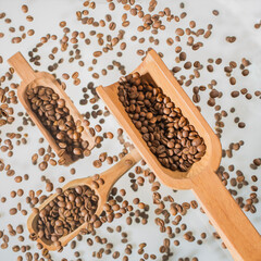 Scoops floating on several planes among coffee beans and white background. Picture with an effect of oil painting.