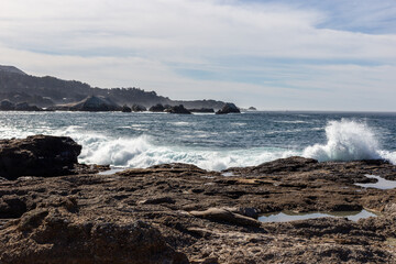 A view on Pacific ocean with rocks and waves