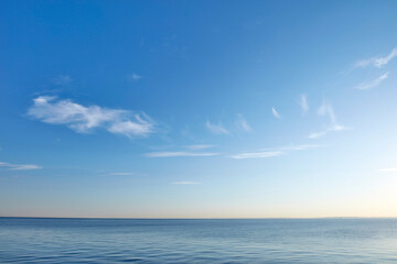 Naklejka na ściany i meble Beautiful, calm and quiet view of the beach, ocean and sea against a blue sky copy space background on a sunny day outside. Peaceful, scenic and tranquil landscape to enjoy a relaxing coastal getaway