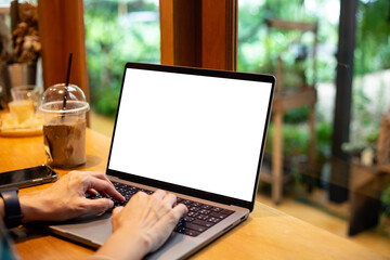 mock up empty screen notebook, businesswoman working on his laptop computer with blank space screen for advertising text on wood desk in Cafe