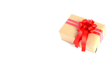 Brown craft gift box with red ribbon bow isolated on white background.
