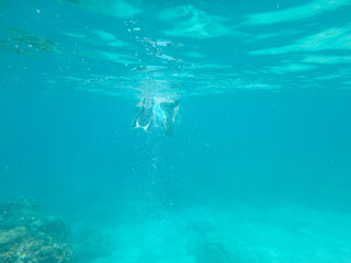 Fototapeta na wymiar diver vanishing underwater in a distance