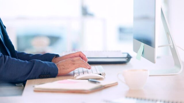 Mans hands typing on computer keyboard in his office desk at work close up. Operations Research Analyst sending feedback on creative data mining methods via email to help the business reduce costs