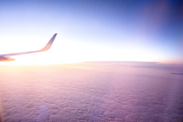 Naklejka na ściany i meble View from the plane on a beautiful orange sunset