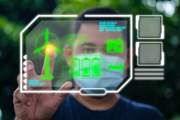 Hand touches a futuristic digital screen with future innovative ideas energy saving, Smart grid. Renewable energy. Sustainable resources. The technology of wind turbines and solar panels