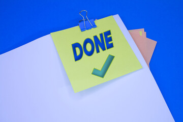 Done text with Checkmark. Text on adhesive note paper. Event, celebration reminder message.