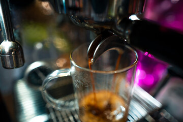 Expresso coffee dripping from the machine