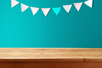 Empty wooden table over green wall background with sticky notes.  Back to school concept for mock...