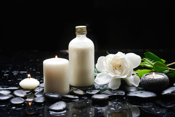 
Zen lifestyle, still life of with
Oil bottle , candle,, gardenia and zen black stones, on wet background

