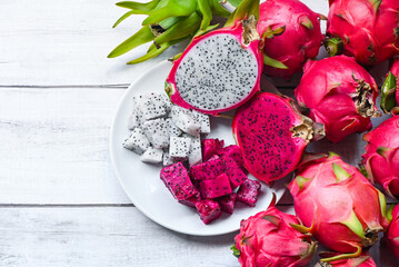 fresh white and pink red purple dragon fruit tropical in the asian thailand healthy fruit concept, dragon fruit slice and cut half on white plate with pitahaya background - 519491134