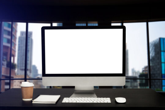 Front view workspace with computer, smartphone and tablet on white desk with blurred background at office