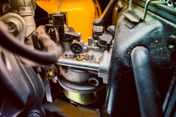 Small carburetor of a gasoline engine of a gasoline electric generator close-up