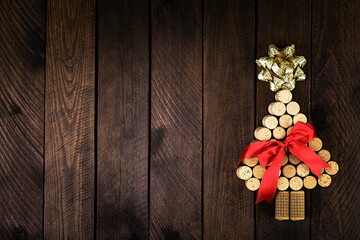 Christmas tree made of wine corks on wooden background. Mockup postcard with Christmas tree and copy space for text. Top view.