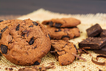 Cookies with chocolate on dark wooden background