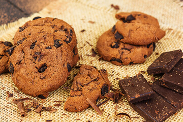 Cookies with chocolate on dark wooden background