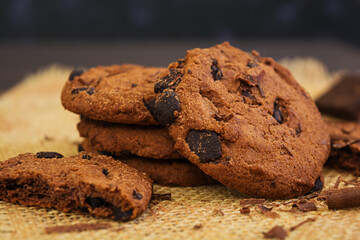 Cookies with chocolate on dark wooden background