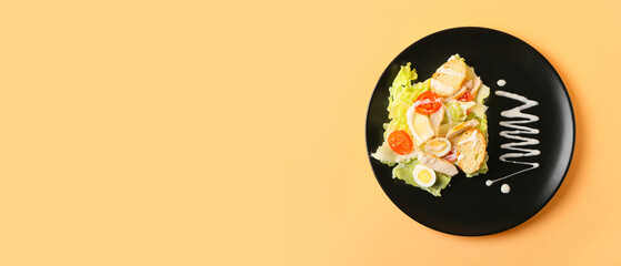 Plate of fresh Caesar salad on beige background with space for text