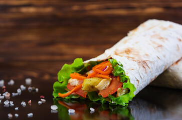 Delicious shawarma sandwich on wooden background